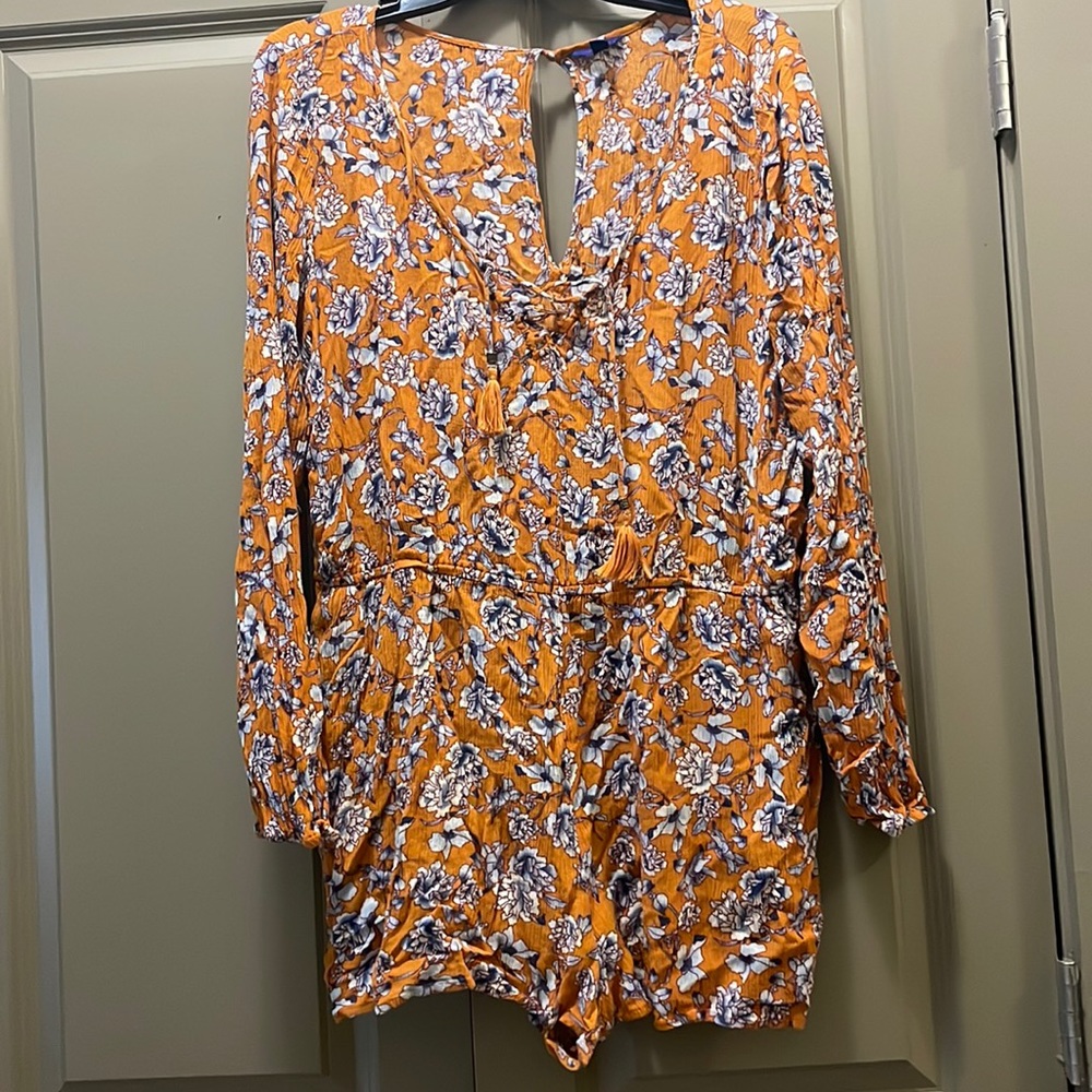 Gold/orange colored floral long sleeve romper